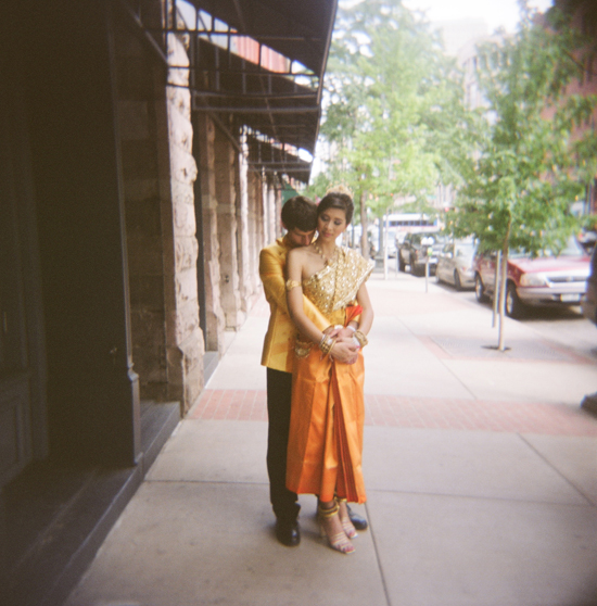 Couple in traditional Thai wedding attire embracing