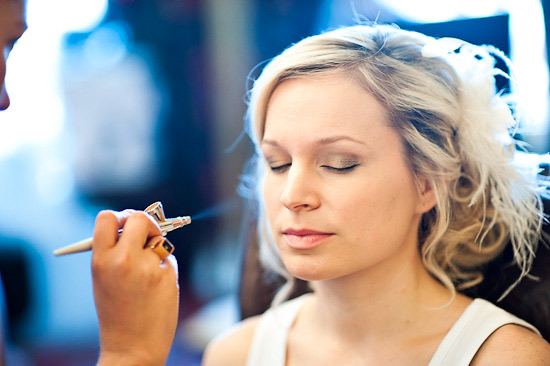 Bride getting airbrush makeup for her wedding day
