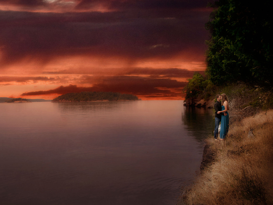 Couple embraces on a cliff at sunset over the water