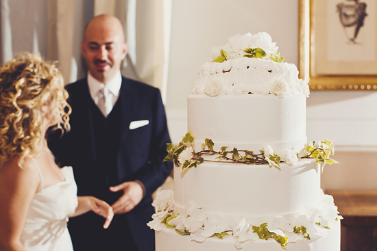 Elegant four-tier wedding cake with white flowers