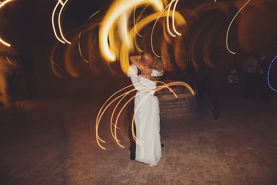Wedding couple embracing, light trails blur background