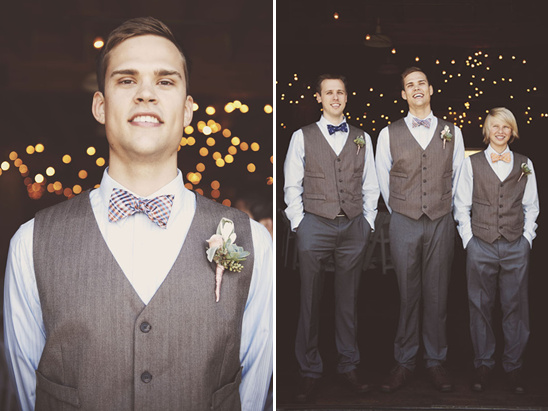 Groomsmen in grey vests and bow ties at rustic wedding