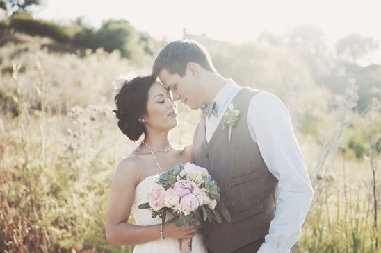 Bride and groom share a tender moment on wedding day