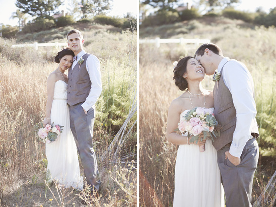 Bride and groom posing in a field on wedding day