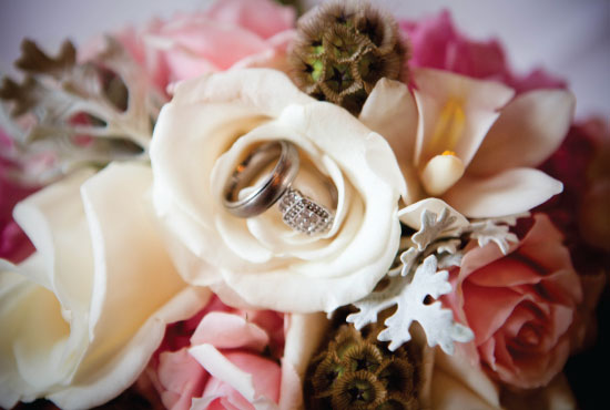 Wedding rings nestled in a bouquet of pink roses