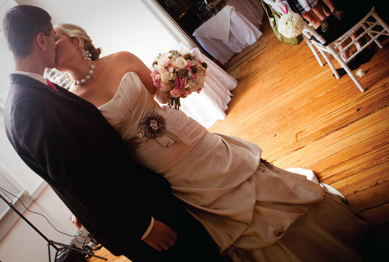 Newlyweds share a tender kiss at their wedding reception