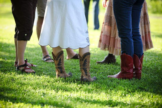 Women in cowboy boots and skirts on grassy field