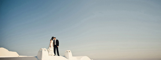 Couple kissing on white roof, wedding photo