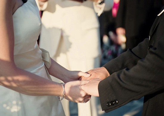 Bride and groom holding hands at a wedding ceremony