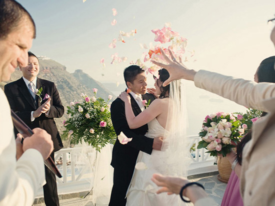 Bride and groom embraced during wedding petal toss