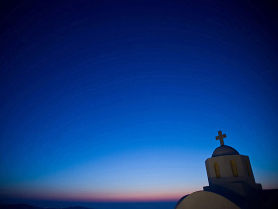 Santorini church dome against a blue twilight sky