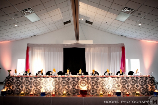 Elegant wedding reception head table with black and white damask tablecloth