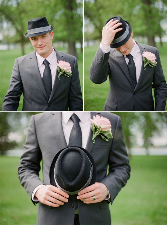 Groom in grey suit, fedora hat, pink boutonniere