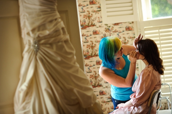 Bride getting makeup applied by stylist