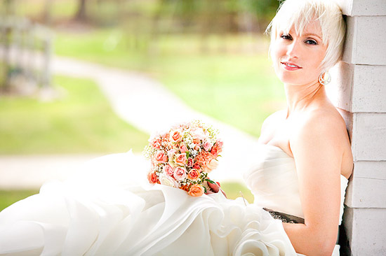 Bride with peach bouquet in white wedding dress