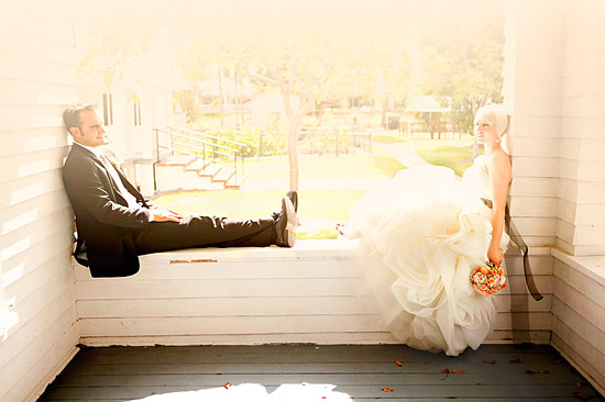 Couple in wedding attire, sunny porch setting