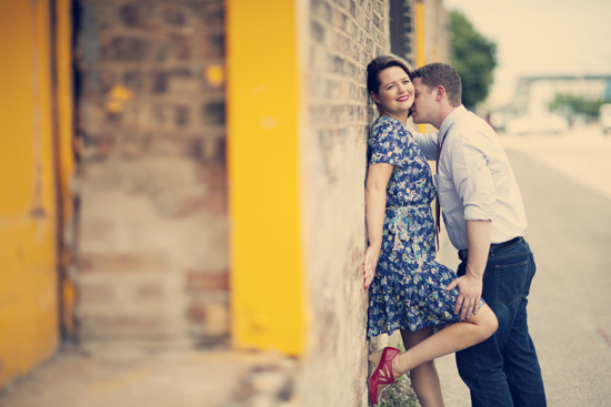 Romantic couple embracing near a yellow wall