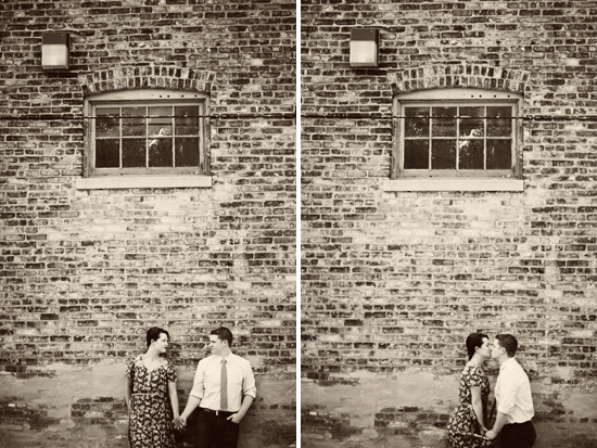 Black and white couple's engagement photo by brick wall
