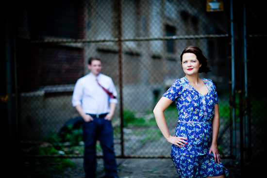 Woman in blue floral dress, man in background
