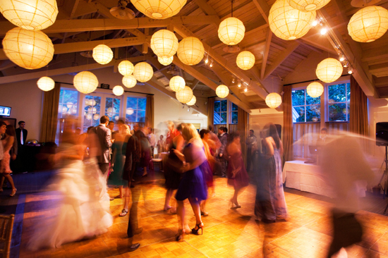 Wedding guests dancing under paper lanterns