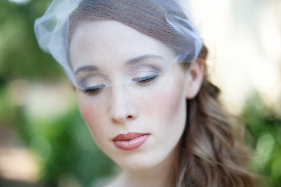 Bride wearing delicate white veil and makeup
