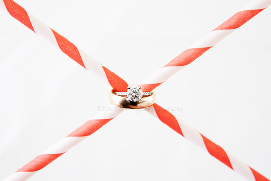 Wedding rings crossed by red and white straws