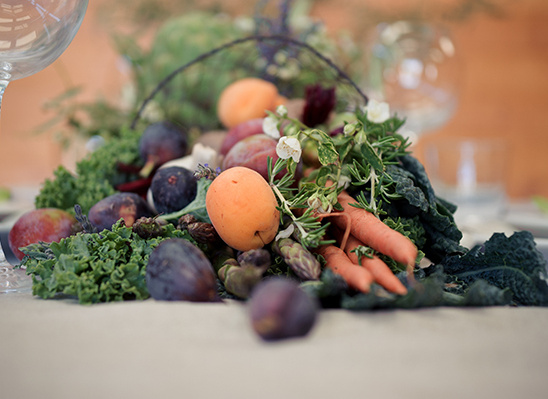 Fresh figs, apricots, carrots, and kale centerpiece