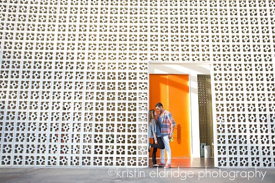 Couple in front of patterned wall