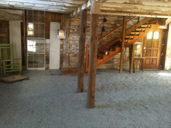 Rustic farmhouse interior with wooden stairs and aged flooring