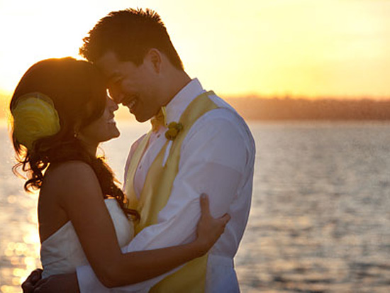 Bride and groom embracing during a romantic sunset wedding