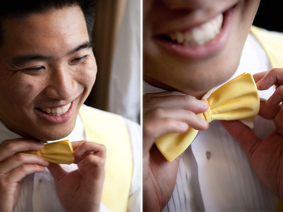 Groom smiles adjusting his bright yellow bow tie