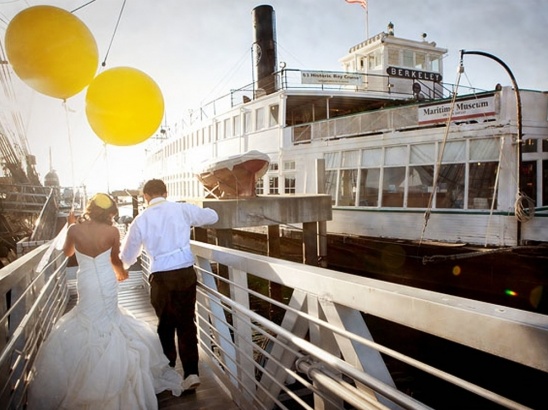 Newlyweds celebrate by the Berkeley Maritime Museum boat