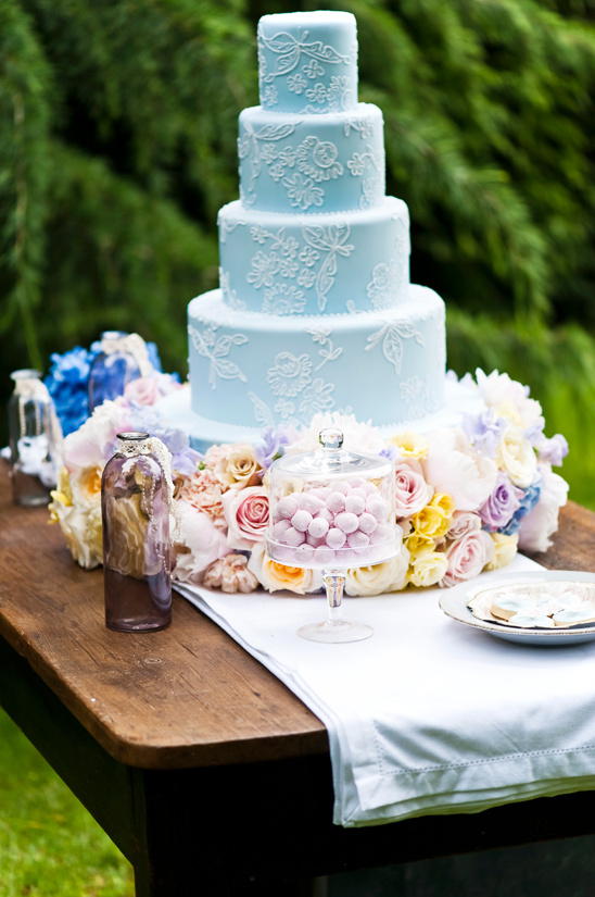 Pretty light blue tiered wedding cake with lace design