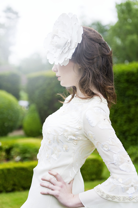 Woman in white dress with flower hat