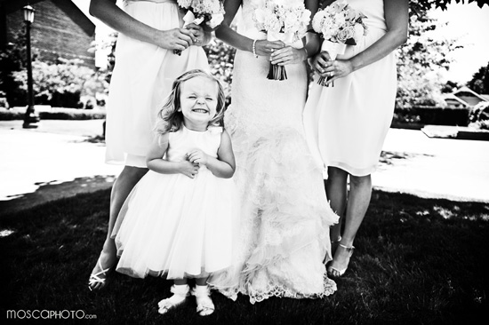 Smiling flower girl in white dress at wedding