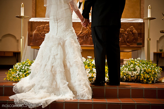 Bride and groom holding hands during wedding ceremony