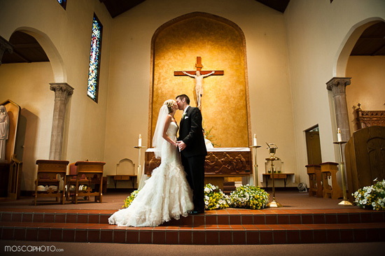 Newlyweds share a kiss in a church ceremony