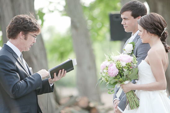 Outdoor wedding ceremony with couple and officiant