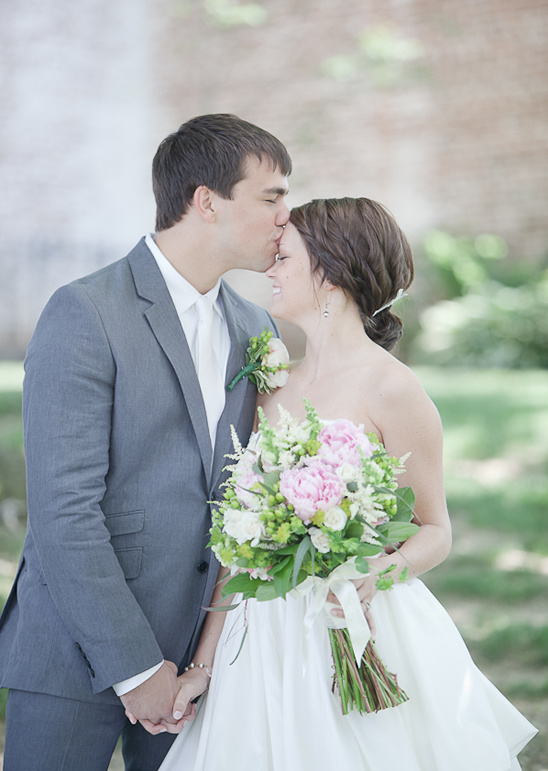 Groom kissing bride's forehead, wedding couple