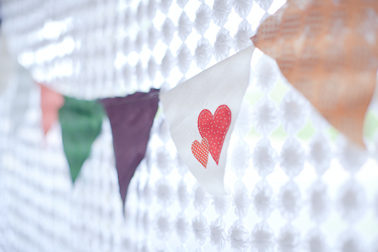 Fabric heart bunting hanging near a lace curtain