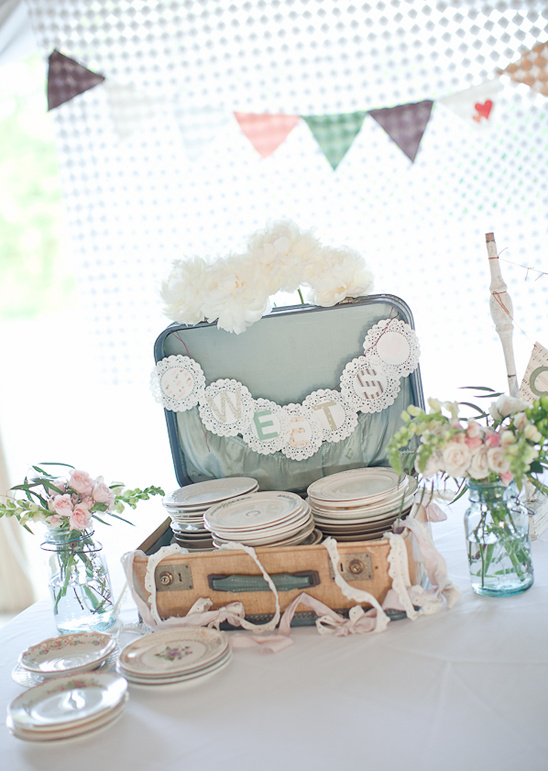 Vintage suitcase with plates and floral decorations