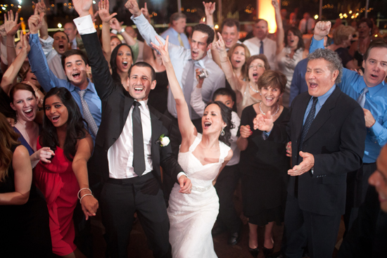 Happy wedding guests dancing