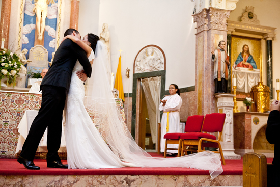 Newlyweds share a tender kiss after their church wedding ceremony