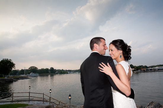 Happy couple embraces by the water