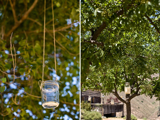 Mason jars hang from trees for outdoor decor