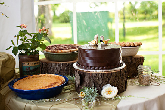 Wedding cake and pies on rustic wooden stands