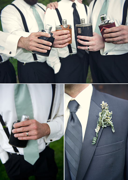 Groomsmen in suspenders holding flasks at a wedding