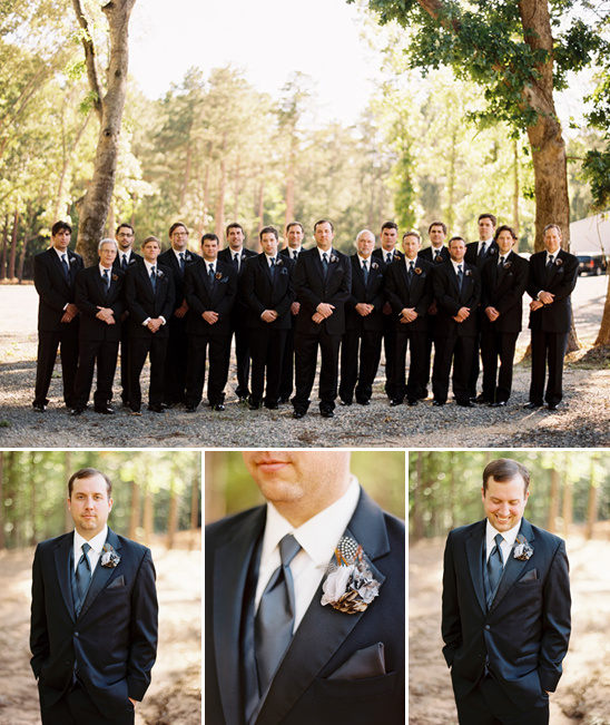 Wedding party in black suits with boutonnieres outdoors