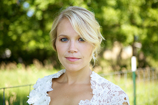Blonde bride with blue eyes in lace bolero wedding look