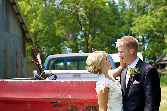 Happy bride and groom embrace near a truck